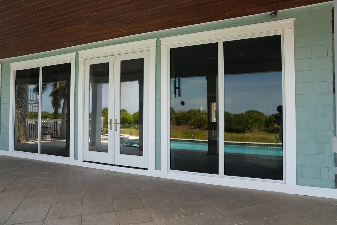 Streak-free patio doors reflecting the pool after a Clarity cleaning